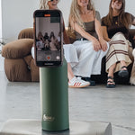 MagSafe® Water Bottle - Purple holding a phone