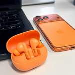 Orange Fuse Airbudz 3 Noise Cancelling Earbuds next to an orange iPhone